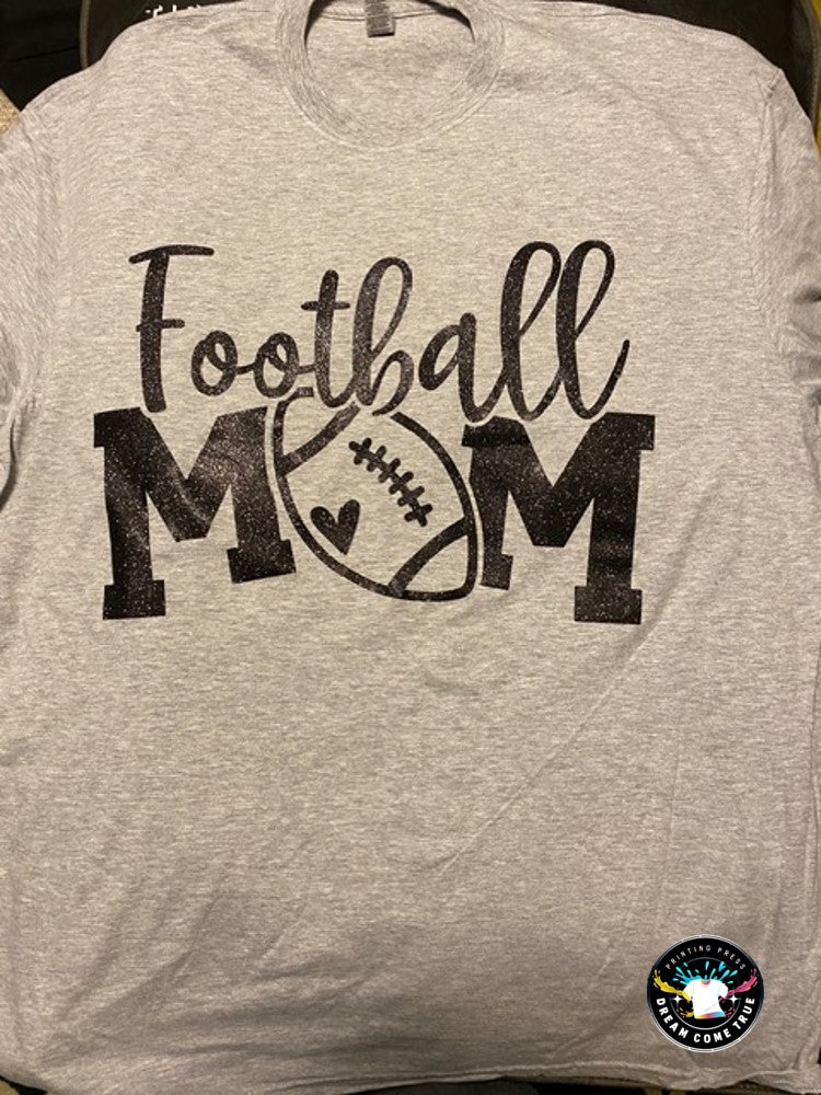 Gray t-shirt with 'Football Mom' text and football graphic at Dream Come True Printing Press.