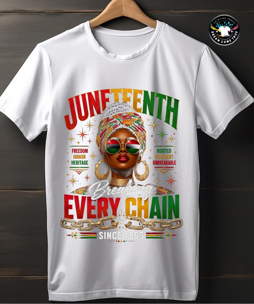 White t-shirt with Juneteenth design featuring a woman's portrait and text on a wooden background at Dream Come True Printing Press.